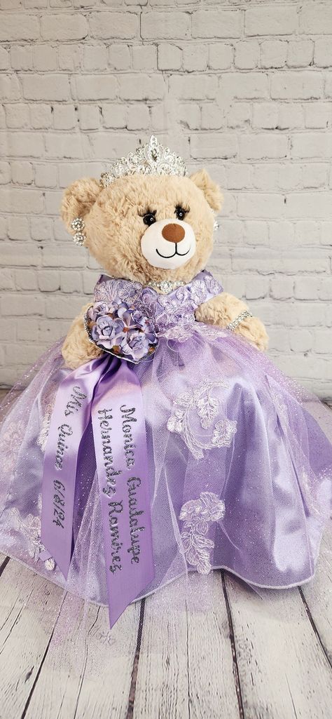 Custom Personalized Quinceanera Bear/Last Doll/Oso made to look just like the quinceanera's dress. Attention to detail is my forte.  Includes the 20" bear, dress, tiara, lashes, bouquet and jewelry. Please allow more than 8 weeks to make the bear.  May be longer during peak season.  Please message me with the following information: - Pictures of the front and back of the dress. - Color description as sometimes the pictures may appear differently.  - Date of the Quinceanera - Color of accessories (silver, gold, rosegold) - If you need it sooner than 8 weeks, please select the Rush Fee and add it to the cart. - If you would like the additional accessories, please add the accessory upgrade to the cart.  Upgrade includes metal tiara with stones, heels to match her dress, and doll stand so that Build A Bear Quinceanera Dress, Quinceanera Bear Purple, Quinceanera Doll Purple, Ultima Muñeca Quinceanera Ideas, Sofia The First Quinceanera Theme, Sofia The First Quinceanera, Quince Last Doll, Rapunzel Theme Quinceanera, Lavender Quince Dress