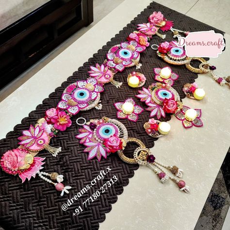 Evil Eye Premium Combo 🧿✨️ 2 Colour options available - Pink and Blue Evil Eye bandhanwar - approx 40 inches Jute base Handwork patches Artificial flowers Evil Eye Shubh Labh Hangings Approx 18 inches length Handwork patches Artificial flowers Cutdana work patches and hangings Rangoli Set of 7 pcs 1 Centre piece 7 inches approx 3 Mirror Handwork t-light holders 3 Jute t-light holders Options With wax With LED #evileye #shubhlabh #bhandwar #diwalidecor #diwali Diwali Hanging Decorations, Toran Design, Diwali 2024, Handmade Decorative Items, Cutdana Work, 3 Mirror, Diy Diwali Decorations, Diwali Decor, Diwali Craft