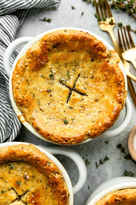 The classic comfort food dinner recipe, made mini: Individual Chicken Pot Pie! A creamy pot pie filling with tender chicken & hearty vegetables is individually portioned & topped with homemade all-butter pot pie crust studded with fresh herbs for extra savory flavor. Bake until the pastry is flaky & golden for a super cozy dinner. Great for date night or any chilly winter evening! (Easy make-ahead instructions provided.) #chickenpotpie #potpiecrust #individualchickenpotpies #minichickenpotpies Creamy Pot Pie, Pot Pie Crust, Pie Night, Winter Comfort Food Recipes, Individual Chicken Pot Pies, Herbed Butter, Mini Pot Pies, Chicken Pot Pie Filling, Savory Pies Recipes