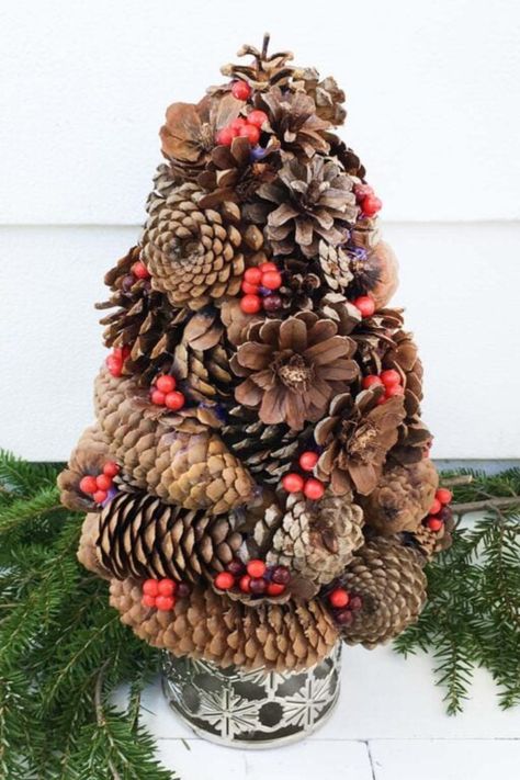 Bring the holiday spirit to small spaces with this delightful pinecone Christmas tree! Decorated with red berries, this tree combines natural elements with festive charm, perfect for apartments or cozy corners. It’s a unique way to celebrate the season without the need for a full-size tree. Get inspired by more small Christmas tree ideas in our blog post and create a holiday look that fits your space beautifully! Small Christmas Tree Ideas, Pinecone Christmas Tree, Pinecone Christmas, Christmas Tree Decorated, Small Christmas Tree, Norfolk Pine, Twig Tree, Fabric Tree, Cone Trees