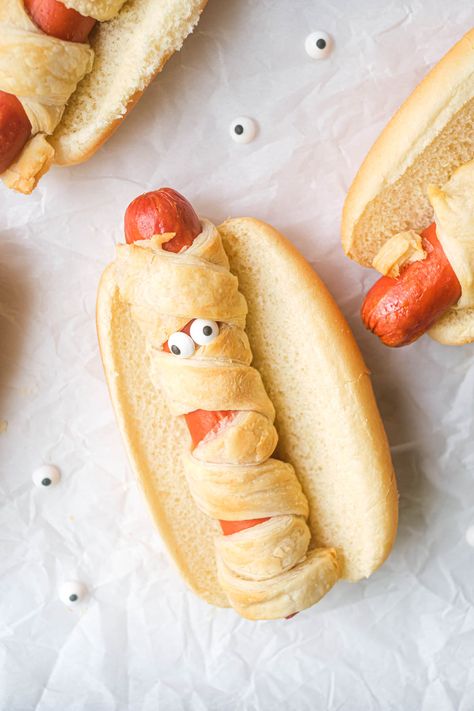 close up view of one of the mummy hot dogs from the air fryer mummy dogs recipe Hot Dog Halloween Food, Halloween Appetizers Hot Dogs, Mummy Dogs For Halloween, Halloween Hot Dog Mummies, Halloween Mummy Hot Dogs, Mummy Hot Dogs, Easy Halloween Party Food, Mummy Dogs, Dash Recipe