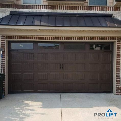 Dark brown double garage door with grooved panels, windows and decorative hardware by ProLift Garage Doors of Chattanooga Brown Garage Door, Contemporary Garage Doors, Garage Door Colors, Double Garage Door, Carriage House Garage Doors, Garage Door House, Garage Door Paint, Carriage Garage Doors, Dark Doors