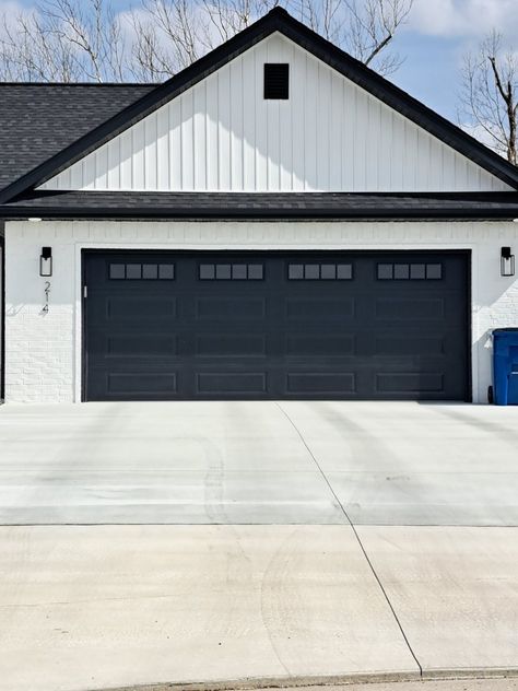 Dark Garage Doors White House, Red Brick House Black Garage Door, Black Garage Door White House, Black Garage Door With Windows, White House Black Garage Door, Garage Design Exterior, Modern Farmhouse Garage Doors, Garage Doors Black, Black And White Exterior House