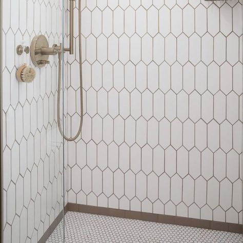 Recreate this fabulous shower for your new bathroom remodel.  It's comprised of three patterns and the brown subway it the frame where the elongated hex tile meets the penny round tile.   Please see the carousel for closeups of the three tile design that make up this shower.  
This shower inspiration is part of the Bathroom in a Box Crewe Design Collection.  The rest of the products to complete the bathroom remodel are shown with links on where to purchase. Penny Stone Tile Bathroom, Penny Tile In Bathroom, Penny Round Bathroom Floor, Penny Round Tile Bathroom Floor, Penny Tile Shower Wall, Picket Tile Bathroom, Penny Round Tile Bathroom, Tile In Bathroom, Penny Tiles Bathroom