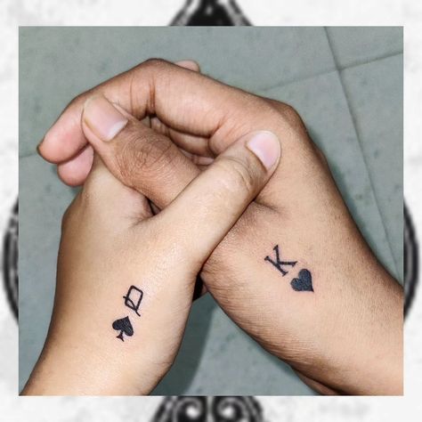 The tattoo showcases the symbols "Q ♠" (Queen of Spades) and "K ♥" (King of Hearts) and holds deep meaning for the couple. It's a beautiful representation of the strong connection between the two individuals, portraying them as the King and Queen in each other's lives. The choice of card suits—spades and hearts—reflects a harmonious balance of different personality traits or aspects of their relationship. The queen of spades embodies creativity and foresight, symbolizing a woman who is always... Queen Card Tattoo For Women, Card Symbol Tattoo, King Card Tattoo, K King, Ace Of Spades Tattoo, Queen Of Hearts Tattoo, Spade Tattoo, King Card, Card Suits