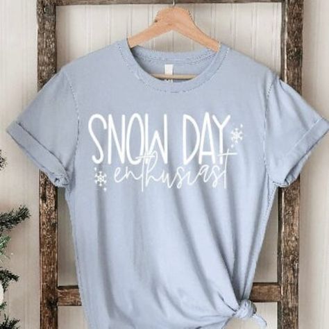 Listing: (1)-Snow Day Enthusiast Shirt Perfect winter shirt for teachers. Great to celebrate the holiday season and snow days with this winter!  Main photo: Light blue shirt with white lettering.   Following listing photos.... Deep heather, and black shirts featuring white lettering. Followed by Pink, Mint, and White shirts featuring black lettering. See more holiday and winter items here: https://www.etsy.com/shop/tcctn?section_id=27290931 Branding: Adult:  Bella Canvas/Next Level Unisex fit.  *Size chart in photos section *Tops are not pre-knotted. Knotting only shown for styling purposes.  Care Instructions:  Turn inside out wash on gentle & dry on low.  I use high quality cotton tops & bodysuits. Brand varies depending on availability.  *Personalized items are not able to be returned o Sunshine Committee, Snow Day Outfit, Winter Items, School Clothing, No School, Light Blue Shirt, Winter Shirts, Holiday Tops, Light Blue Shirts