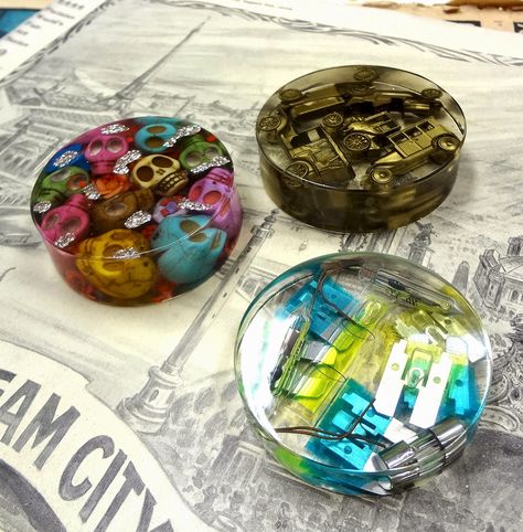 Over the last week I have made some of the best paperweights! I have to start this post with a “I do not recommend doing this message.” These are my molds for making bangles.  I was looking at them and thought, “if I turn them over, they are a nice paperweight size and shape.”  Good...Read More Symbolic Gifts Ideas, Paperweights Diy, Paperweight Ideas, Resin Paperweights, Paper Weights Diy, Epoxy Molds, Play Button, Resin Ideas, Epoxy Resin Crafts