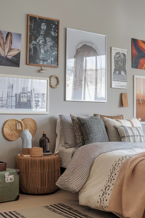 Cozy bedroom with a bed adorned with patterned pillows, a wicker side table holding decorative items, and a gallery wall with various framed artworks. Cream Bedroom Aesthetic, Gray Boho Bedroom, Earthy Paint Colors, Global Inspired Decor, Vintage Rattan Furniture, Boho Bedroom Inspirations, Boho Bedroom Decor Ideas, Cream Bedrooms, Boho Bedroom Design