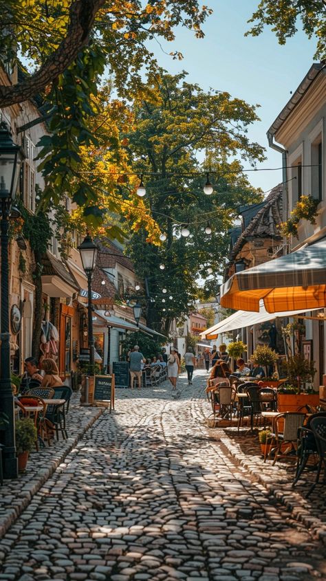 Cobbled Street Charm: Quaint #cobblestone street bustling with activity as people enjoy #outdoor #dining under the shade of #trees. #aiart #aiphoto #stockcake ⬇️ Download and 📝 Prompt 👉 https://stockcake.com/i/cobbled-street-charm_762832_1015428 Cobble Stone Streets, Paris Street Cafe, Beach Rain, Dream Cafe, Cobblestone Street, Sidewalk Cafe, Stone Street, Cobblestone Streets, Parisian Cafe