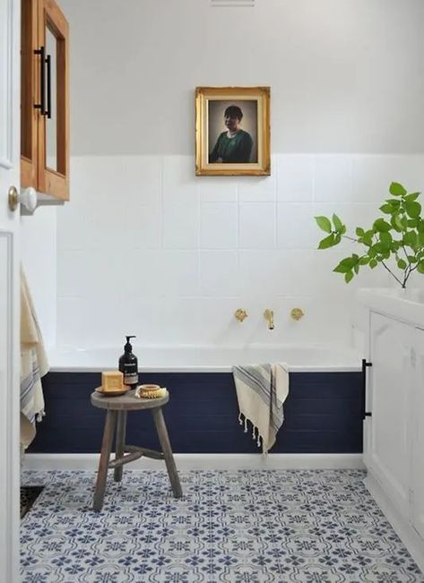 a stylish modern bathroom with blue Moroccan tiles, a bathtub clad with navy tiles, a cabinet, an artwork and a white vanity Navy And White Bathroom, Blue Moroccan Tiles, Creativity Painting, Blue Moroccan Tile, Solid Oak Coffee Table, Bathroom Improvements, Creative Bathroom, White Appliances, Unique Tile