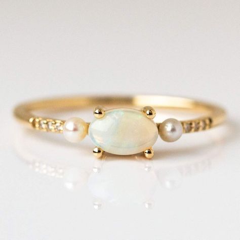 Opal luminescence, diamond sparkle, and pearly glow make up this solid gold ring from La Kaiser.  With a gorgeous vintage inspired design and a trio of trendy gems, this ring is equal parts modern and classic. To customize or order this ring in other sizes please reach out to concierge@localeclectic.com. Natural Austra Opal Pearl Ring, Pearl And Opal Ring, Opal And Pearl Ring, Unconventional Wedding Rings, Diamond Cuff Ring, Pink Wedding Rings, Ruby Wedding Band, Total Girl, Non Traditional Wedding