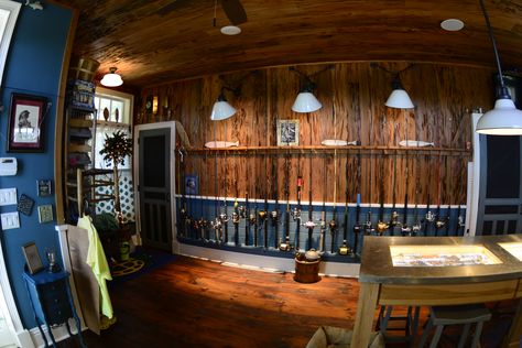 The perfect fishing rod storage in this custom tackle room.  The pecky cypress wall works beautifully with the rich blue wainscoting. Fishing Rod Wall, Old Florida Fish Camp Decor, Fishing Room Ideas, Fly Fishing Room, Fishing Room Man Caves, Fishing Storage Ideas, Fishing Workshop, Blue Wainscoting, Fishing Tackle Room