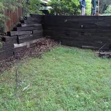 Why We Don't use Railroad Ties - Bailey Construction & Landscaping Landscape Railroad Ties, Railroad Ties Landscaping Retaining Walls, Railroad Tie Retaining Wall Landscaping, Retaining Wall With Railroad Ties, Railroad Tie Seating, Railroad Ties Driveway Entrance, Railroad Ties Ideas Landscaping, Retaining Wall Railroad Ties, Landscaping With Railroad Ties Ideas