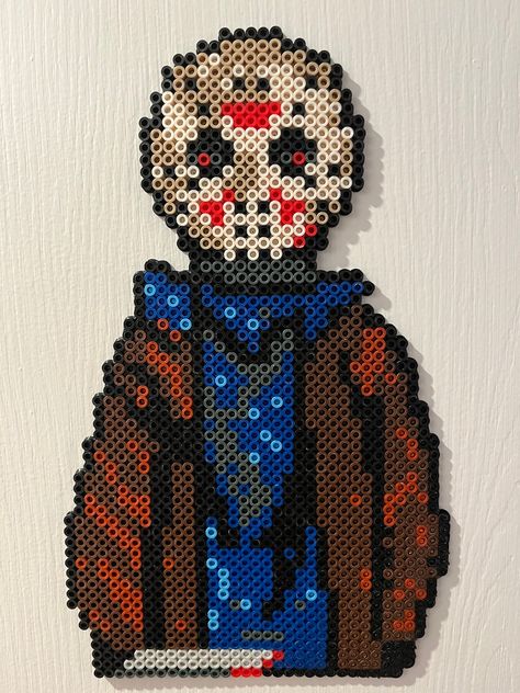 This is a handmade custom Jason Voorhees design made of perler beads. This can be framed or displayed as is. Very lightweight and easy to display in any horror collection, display, or setting. Perfect for any and all horror fans. Corpse Bride Perler Beads, Horror Perler Beads, Alpha Crochet, Horror Crafts, Melt Beads Patterns, Horror Collection, Jason Vorhees, Perler Ideas, Hamma Beads