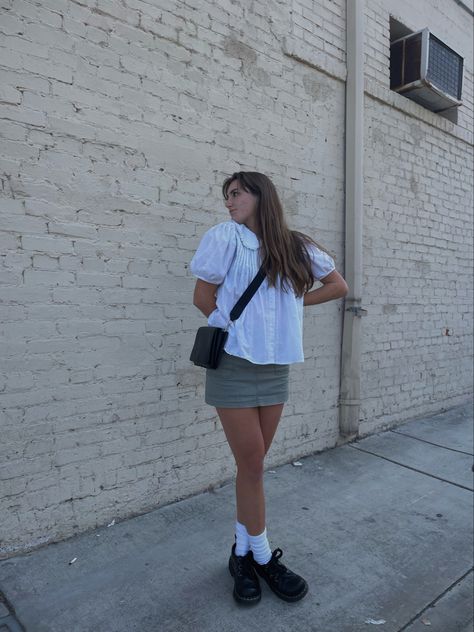 girl in dr martens, green cargo mini skirt and white ruffle shirt posing in front of white brick wall Brick Wall Instagram Pictures, Brick Wall Pictures Ideas Instagram, Brick Wall Photoshoot Ideas, Brick Wall Photoshoot, White Brick Wall, Downtown Aesthetic, Aesthetic Fit, Pic Inspiration, Cute Instagram Pictures