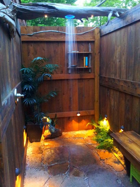 outdoor shower we built out of repurposed lumber. 1950 garage door, also drift wood logs, and sandstone rock found in a pile. Cabin Outdoor Shower Ideas, Outdoor Shower Rustic, Outdoor Shower Sauna Combo, Pallet Shower Outdoor, Outdoor Shower House, Boho Outdoor Shower Ideas, Beach Outdoor Shower Ideas, Outside Toilet Ideas Outdoor Bathrooms, Rv Shower Ideas