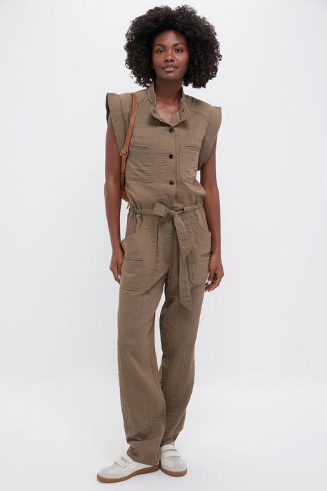 The ultimate jumpsuitThe Khaki Suzie Jumpsuit is an adventurer style jumpsuit. With a round snap collar, cap sleeves, front welt pockets, and a drawstring waistband, this style is is perfect for your next adventure. Whether you are going on a safari, or chasing your little ones, we styled this jumpsuit with a chic sneaker and shoulder bag for effortless style!Our Favorite Details: 
Band collar
Cap sleeves 
Chest welt pockets 
Front button placket
Drawstring waist  
Material: 48% Viscose, 29% Cotton, 23% Nylon (outer), 100% Cotton (inner)Care: Dry cleanAbout the BrandFounded in Paris in 1995, Isabel Marant remains a veritable and “most unruly” French fashion house. With a love for materials that live and travel, Isabel draws global inspiration to dress women for their real lives. Her label Adventurer Style, Style Jumpsuit, Chic Sneakers, American Red Cross, Adventure Style, Isabel Marant Etoile, Band Collar, French Fashion, Drawstring Waistband