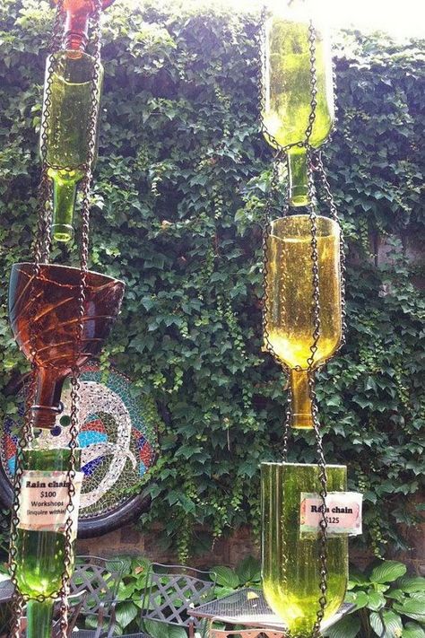 Up Cycled Wine Bottle Rain Chain. Not only make a good sound and enhance your house exterior appearance, but also divert water away from your house. Wine Bottle Outdoor, Rain Chain Diy, Garage Goals, Rain Catcher, Sustainable Diy, Garden Sanctuary, Chain Ideas, Rain Chains, Backyard Greenhouse