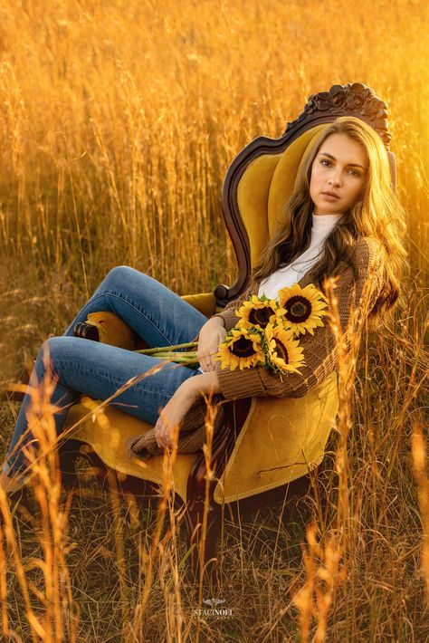 Fall Field Senior Pictures, Senior Pictures In Chair, Senior Picture Ideas Painting, Senior Picture Ideas With Sunflowers, Field Chair Photoshoot, Senior Sunflower Pictures, Creative Senior Photoshoot Ideas, High Grass Photoshoot, Senior Picture Chair Poses