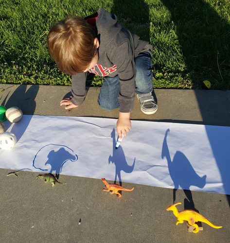 By far my favorite outdoor preschool activity. Shadow tracing with dinosaurs. This was so fun and my 3 year old loved it!! Dinosaurs Arts And Crafts For Preschoolers, Dino Day Preschool, Outdoor Art Activities For Preschool, Dinosaur Outdoor Activities Preschool, Outdoor Activities For 3-5, Dinosaur Outside Activities, Dinosaur Nature Activities, Preschool Dinosaur Activities Art, Hand Print Activity For Preschool