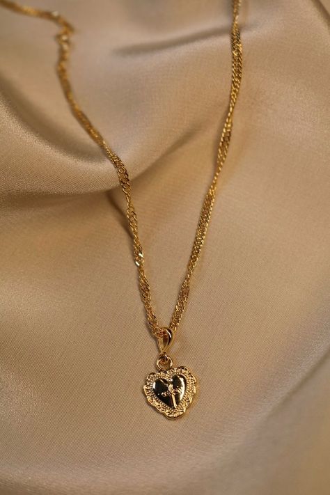 Pretty Gold Heart Necklace This gold-plated heart necklace is so cute, you'll never want to take it off! It features a simple gold chain and a heart pendant with a cross engraved on it. Pair this with our gorgeous Amore Earrings to spruce up the charm factor of any look. You can even layer it... Heart Cross Necklace, Diamond Solitaire Necklace, Gold Cross Necklace, Solitaire Necklaces, Gold Heart Necklace, Emerald Necklace, Jewelry Inspo, Dream Jewelry, Pretty Jewellery