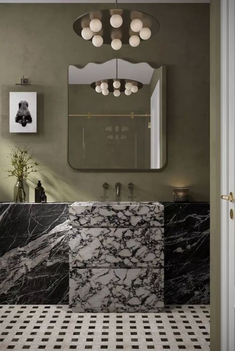 Ashley Ross, founder and Creative Director of Muse Noire Interiors, shares her design journey and explains how she and her team create a contemporary global aesthetic in every room they design. Like this stunning bathroom that is full of moody colors and two black marble elements for the sink and on the walls. #luxurybathroomideas #marblebathrooms #wallpaperideas #thespruce #blackinteriordesigners #interiordesignideas #homestylingtips #homedecorinspo #apartmentdecorideas Black Marble Wall Bathroom, Contemporary Marble Bathroom, Marble Sink Bathroom, Global Aesthetic, Black Marble Bathroom, Moody Bathroom, Black Designers, Moody Colors, Marble Sink