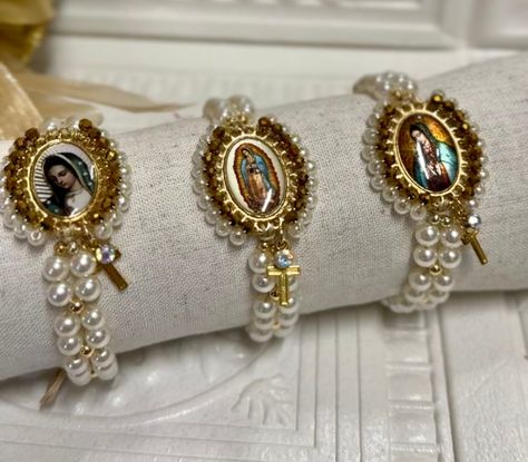 Virgencitas Adjustable Bracelet  Beautiful adjustable thread bracelets Religious jewelry  Protection Bracelets  Oval medal embroidered with crystal glass. 14 k gold plated beads  Faux pearls Medal gold plated with resin. 100% Nylon Thread  The bracelet is adjustable fits most wrist sizes.   Include jewelry dust bag and prayer (Spanish) Care Instructions: To ensure that your bracelet lasts, you shouldn't shower, swim, sleep, sweat (exercise) while wearing your jewelry. Like all handmade jewelry p Mexican Bracelets With A Cross Charmhandmade, Silver Our Lady Of Guadalupe Jewelry For Wedding, Virgin Mary Bracelet Handmade, Spiritual Our Lady Of Guadalupe Bracelets As Gifts, Multicolor Our Lady Of Guadalupe Jewelry As A Gift, Embroidered Bracelet, Boutique Decor, Thread Bracelets, Protection Bracelet