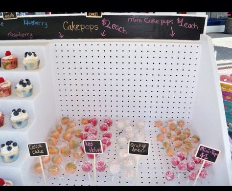 Cake pops display with chalkboard sliver on top Cake Pop Vendor Display, Cake Pop Market Display, Cake Pops Display, Festival Vendor, Bake Sale Displays, Cake Pop Display, Dessert Business, Cake Pop Displays, Farmers Market Display