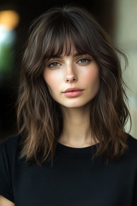 Blunt bangs are a bold hairstyle option that can dramatically change your look. With their straight cut across the forehead, they frame the face and emphasize the eyes. These bangs suit many hair types, from thick to fine, and add a chic, modern flair to both long and short hairstyles. Whether worn with layered cuts or sleek, straight locks, blunt bangs offer timeless appeal. Their versatility in styling makes them a perfect choice for creating an effortlessly cool and stylish vibe. High Forehead Bangs, Thick Straight Bangs, Ash Brown Hair With Bangs, Fringe Bangs Small Forehead, Black Lob Hair With Bangs, Short Wolf Cut With Bangs, Textured Lob With Bangs, Bluntbob Bangs, Straight Hair With Bangs