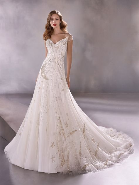 Intergalactic: This A-line gown is a masterpiece in embroidery, featuring immaculate, hand-beaded suns, moons, stars, and galactical streams in silver and gold atop soft layers of light tulle. From Atelier Pronovias 2020. Pronovias Wedding Dress, Wedding Dress Cap Sleeves, Celestial Wedding, Gown Photos, Wedding Dress Pictures, Wedding Dresses Photos, Lela Rose, Gorgeous Wedding Dress, Bridal Fashion Week