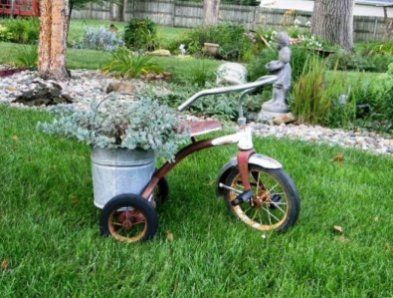 Judy Showen Bicycle Planter Ideas, Tricycle Planter, Corner Gardens, Bicycle Crafts, Garden Shelf, Bicycle Ideas, Bike Baskets, Junk Ideas, Flea Market Gardening