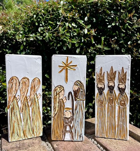 This is a hand painted heavily textured 3 piece nativity scene/manger scene on solid wood blocks.  Each piece is highlighted with metallic gold paint creating beautiful depth.  A great addition to any Christmas decor or to leave out all year to celebrate the birth of Jesus! Approximate dimensions:  9" tall x 3 1/2" wide x 1 1/2" thick Nativity On Canvas, Hand Painted Nativity Scene, Abstract Nativity Scene, Christmas Window Painting Nativity, Painted Christmas Scenes, Painted Wood Blocks Christmas, Diy Nativity Painting, Wood Block Painting Ideas, Christmas Manger Scenes