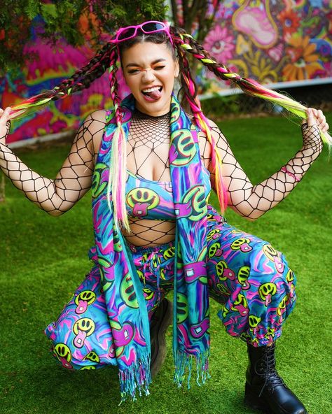 Put on the Happy Hour Set and instantly feel the night come alive! This multicolored set has a comfortable fit, and a crazy good UV-reactive print that produces a euphoric neon glow under festival lights. #ravesets #raveoutfit #festivaloutfit #electricdaisycarnival #electriclove #trippy #trippyoutfits #electriclove #iheartraves #uvreactive