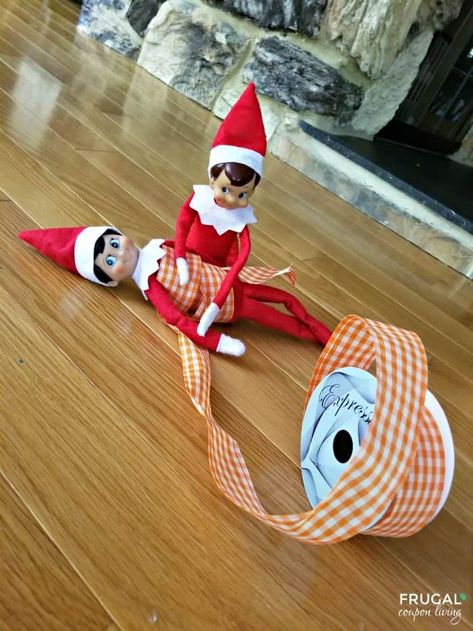 Elf on the Shelf Ideas for Multiple Elves like this Rolled Up Elf on the Shelf Ribbon idea. New Elf on the Shelf ideas daily plus free Elf on the Shelf printables. #FrugalCouponLiving #ElfontheShelf #ElfontheShelfIdeas #ElfIdeas #funnyelfideas #funnyelfontheshelf #elfprintables #freeelfprintables #printables #freeprintables #ElfonaShelf Twin Elf On The Shelf Ideas, Elf On The Shelf Double Trouble, Elf On The Shelf Boy And Girl, Elf On Shelf Multiple Elves, Pair Of Elf On The Shelf Ideas, Elf On Shelf Two Elves, Two Elves On The Shelf Ideas Funny, Elf On The Shelf For Two Elves, Multiple Elf On The Shelf Ideas Funny