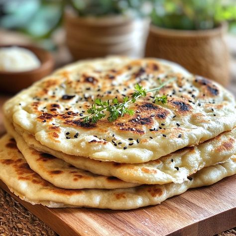 🍞 Plain and Cheese Naans: The Soft and Delicious Indian Flatbread You'll Love! 🧀 Ingredients: - 300 g flour - 1 teaspoon sugar - 1 teaspoon salt - 1/2 sachet baking powder - 1 plain yogurt (about 125 g) - 2 tablespoons olive oil - 100 ml warm water - 100 g grated cheese (mozzarella or emmental type) - A little melted butter for cooking Preparation: In a large bowl, mix the flour, sugar, salt and baking powder. Then add the plain yogurt and olive oil. Mix well to obtain a sandy dough. Gradual... Indian Flatbread, Cheese Mozzarella, Oil Mix, Plain Yogurt, Grated Cheese, Flatbread, Large Bowl, Melted Butter, Immune System