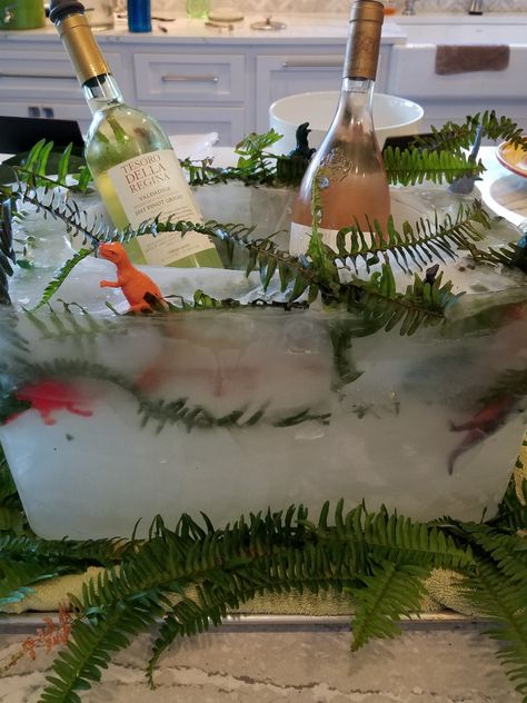 Jurassic Park Party,  Ice Block cooler,  Great way to keep adult beverages cold, or could use for kid drinks... After you let kids take outside and chop open to get dinosaurs.  #Jurassicparkparty   #iceblockbeveragecooler #iceblockwinecooler Jurassic Park Drinks, Dino Party For Adults, Dinosaur 40th Birthday Party, Jurassic Park 30th Birthday, Dinosaur Birthday Party For Adults, Classy Dinosaur Party, Jurassic World Birthday Party Games, Dinosaur Bachelorette Party, Adult Dinosaur Party