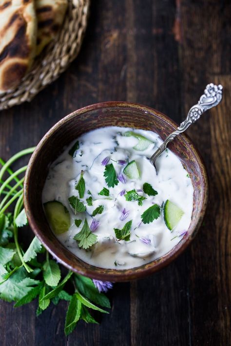 A delicious Raita Recipe- an Indian yogurt sauce with cucumber, mint and cilantro. Cooling and refreshing, serve this with spicy Indian dishes to cool the palate. #raita #yogurtsauce #cucumberraita #indianrecipes Indian Yogurt Sauce, Raita Recipe Indian, Indian Yogurt, Grilled Tandoori Chicken, Indian Sauces, Raita Recipe, Feasting At Home, Cucumber Raita, Cucumber Yogurt