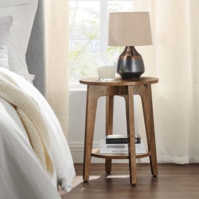 The round tabletop, black finish, and angled legs merge on this small side table, adding a clean, sleek modern vibe to your living space. | Millwood Pines Round Side Table w/ Lower Shelf, End Table for Small Spaces, Living Room, Bedroom Brown 15.7 x 15.7 x 19.7 in | C110551401 | Wayfair Canada Small Spaces Living Room, Bedroom Brown, Shelf Nightstand, Tv Room Design, Table For Small Space, Brown Bedroom, Small Space Living Room, Small Side Table, Drink Table