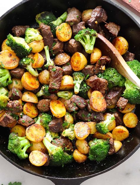 These garlic butter steak bites are out of this world! The steak is juicy, tender, and rich, and it's served with crispy potatoes and sautéed broccoli. Best of all, the entire meal is cooked in one cast iron skillet, making clean extra easy! #cookathomemom Steak Bites And Broccoli, Steak Potatoes And Broccoli, Steak Bites With Potatoes, Steak Bits, Garlic Steak Bites, Sautéed Broccoli, Bbq Chicken Marinade, Garlic Butter Steak Bites, Potatoes And Broccoli