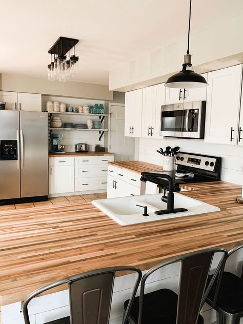 White and black kitchen makeover. Butcher block countertops, black cabinet pulls and light fixtures, shiplap and metal bar stools. We are in love! Grey Walls White Cabinets Kitchen, Butcher Block Countertops Black, White Cabinets Butcher Block Countertops, Kitchen Butcher Block Counters, Barn Office, Wood Shelves Kitchen, Kitchen Storage Bench, Diy Window Seat, Countertops Black