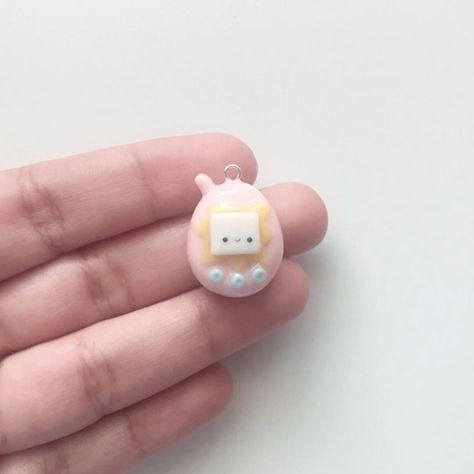 Handmade Clay Creations on Instagram: “Miniature Kawaii Tamagotchi charm with hand painted stars and hearts on each side✨💛 Interested in purchasing? DM me! :) #simplypreciousmade…” Clay Tamagotchi, Tamagotchi Charm, Kawaii Tamagotchi, Painted Stars, Stars And Hearts, Diy Air Dry Clay, Modeling Clay, Cute Clay, Diy Clay Crafts