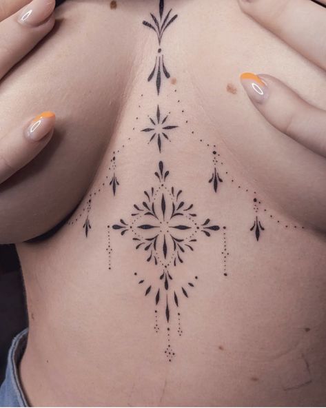 Chandelier Tattoo Chest, Sternum And Stomach Tattoo, Ornament Chest Tattoo, Middle Of Breast Tattoo For Women, Breast Bone Tattoos For Women, Breast Tattoos For Women Middle, Bisexual Tattoo Ideas, Mid Chest Tattoo Female, In Between Breast Tattoo