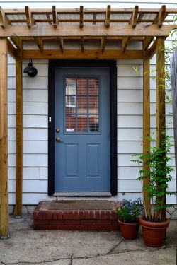 Arbor would be an awesome addition over the back door to provide some protection on the south side. Front Door Arbor, Front Door Pergola, Door Arbor, Pergola Arbor, Door Trellis, Front Porch Pergola, Front Door Overhang, Door Pergola, Brick Steps