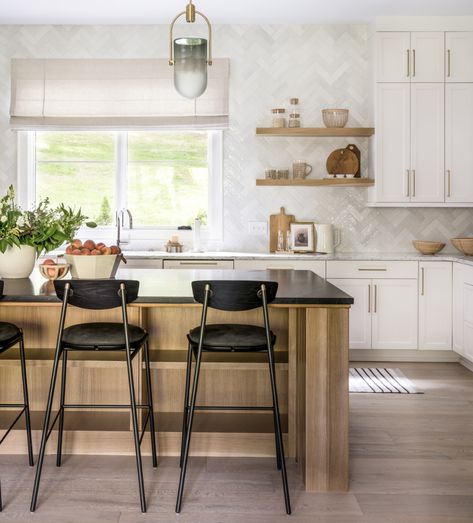 A light and bright kitchen like this one calls for some contrasting touches like our Allemande Bar Stool. The sweet touches of brass make these chairs so chic! Wood Kitchen Backsplash, Townhouse Kitchen, Lindye Galloway, White Shaker Cabinets, Custom Fireplace, Popular Kitchens, Herringbone Tile, Transitional Kitchen, Spacious Kitchens