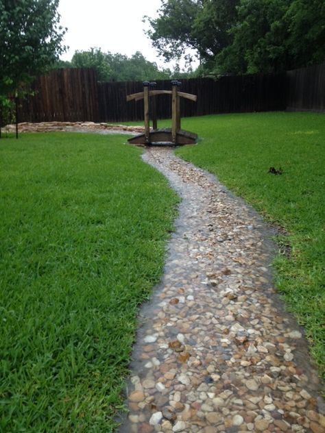 My backyard during heavy rain has extra water flowing from higher lots behind us. After moving in to almost zero grass I could see a problem with excessive standing water between my home and neighbor. I just built a dry creek bed with a catch. Much of the yard has limestone just beneath the surface so during heavy rain we have a creek. Storm Water Runoff Solutions, Creek Ideas Natural, Backyard Water Runoff Ideas, Lowcountry Landscape Ideas, Diy Backyard Creek, Wet Yard Solutions Backyards, Zero Lot Line Landscaping, Rain Scaping Ideas, Rain Scaping