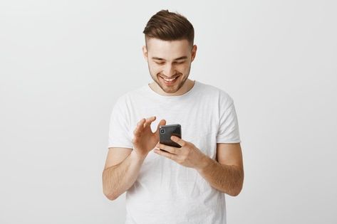 Free Photo | Modern stylish and pleased african american woman using wireless earphones while talking with clients holding smartphone making notes or picking music in device Person On Their Phone, People Using Phone, Staring At Phone, Thumbnail Poses, Person Holding Phone, Man Holding Phone, Social Media Psychology, Captions For Guys, Asos Outfit