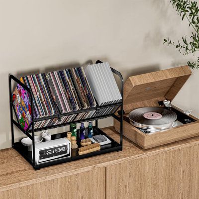 Bottom tray design to store other music-related items such as record cleaners, and more. 17 Stories | 17 Stories Metal 13.4" H Storage Rack Metal in Black | 13.4" H X 15.7" W X 9.4" D | Wayfair Cd Holder Aesthetic, Vinyl Player Stand, Vinyl Records Storage Ideas, Vinyl Holders, Record Player Setup, Records Holder, Cd Stand, Turntable Setup, Vinyl Holder