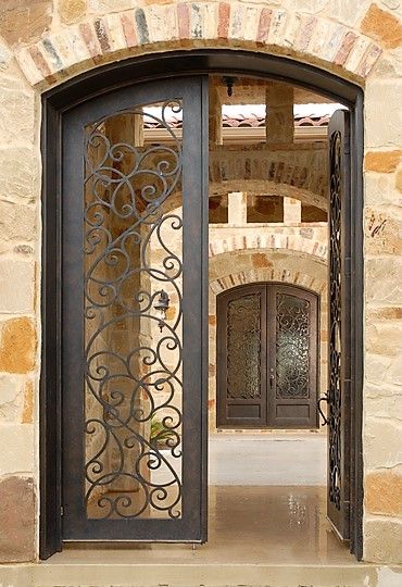 These gorgeous matching wrought iron doors with intricate scrollwork could look perfect in a home with a courtyard or even a wine cellar! Wrought Iron Doors Front Entrances, Wrought Iron Entry Doors, Wrought Iron Front Door, Porte In Ferro, Rustic Front Door, Iron Front Door, Iron Entry Doors, Doors Ideas, Iron Gate Design