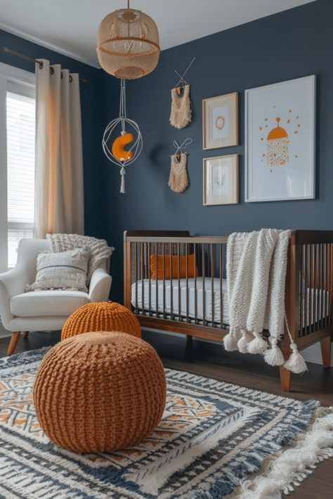 Craft a sophisticated yet playful nursery with navy blue boho interiors. The deep navy backdrop soothes, while vibrant boho accents like mobiles and wall art engage a child's senses. Soft textures and comfy seating ensure both parent and infant comfort, allowing the decor to evolve as the child grows. Navy's timeless, gender-neutral appeal makes it a practical choice for a nursery. Explore more navy chic nursery ideas by tapping here. Rust And Navy Nursery, Peach And Blue Nursery, Blue Accent Wall Nursery Baby Boy, Blue And Rust Nursery, Navy Blue Nursery Gender Neutral, Deep Blue Nursery, Blue And Yellow Nursery Boy, Dark Blue Nursery Boy, Nursery Ideas Navy Blue