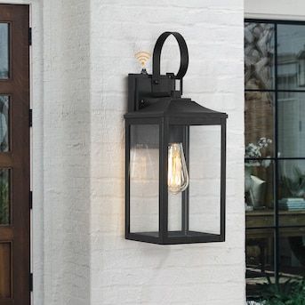 True Fine Norwich 1-Light 18-in H Black Dusk to Dawn LED Outdoor Wall Light in the Outdoor Wall Lights department at Lowes.com Exterior Light Fixture Over Front Door, Black Farmhouse Outdoor Light Fixtures, Black Outside Lights, Outdoor Wall Lights On House Garage, Door Lights Exterior, Outside Lights Front Door, Garage Door Lights Exterior, Exterior Lights On House, Outdoor Wall Sconces Exterior Lighting